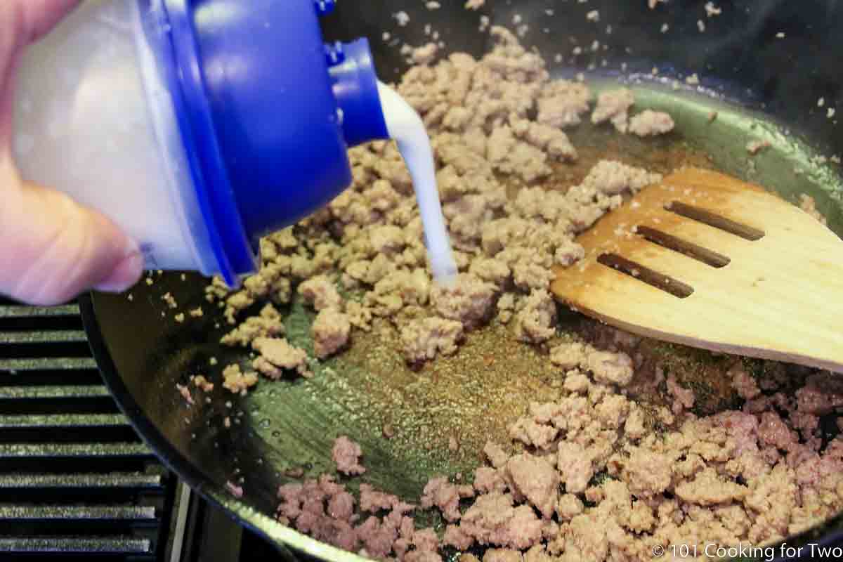 adding flour slurry to browned meat in skillet.