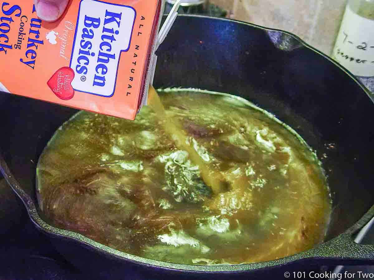 adding turkey stock to pan for gravy.