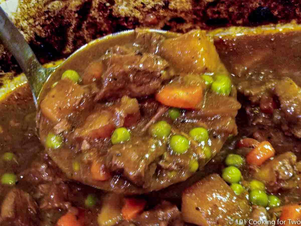 beef stew in a ladle.
