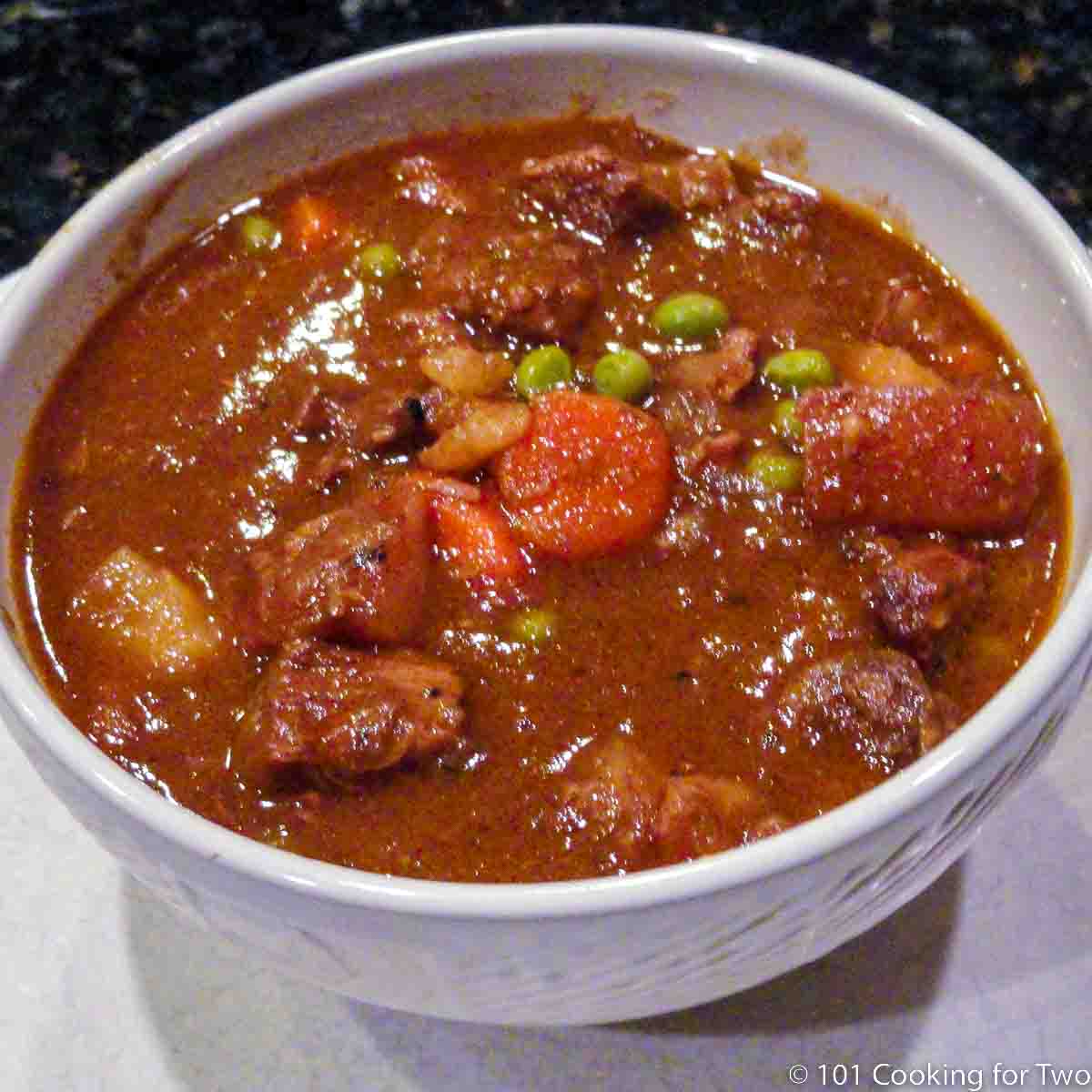 beef stew in a white bowl.