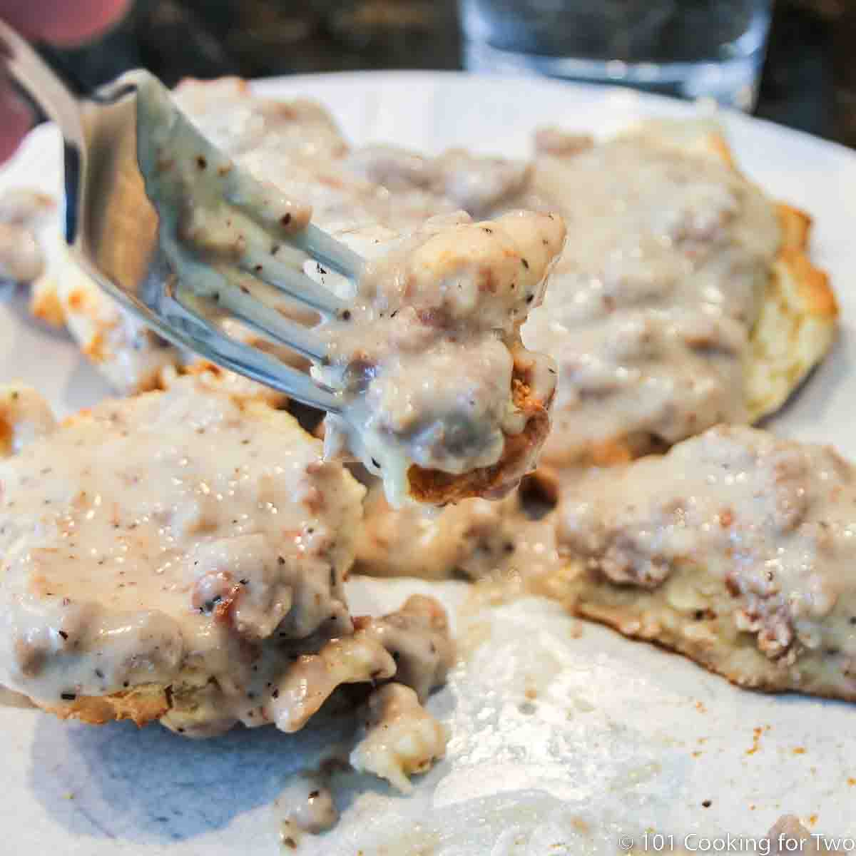 bite of biscuits and gravy on a fork.