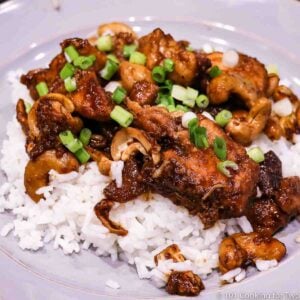 cashew chicken on with rice on a gray plate