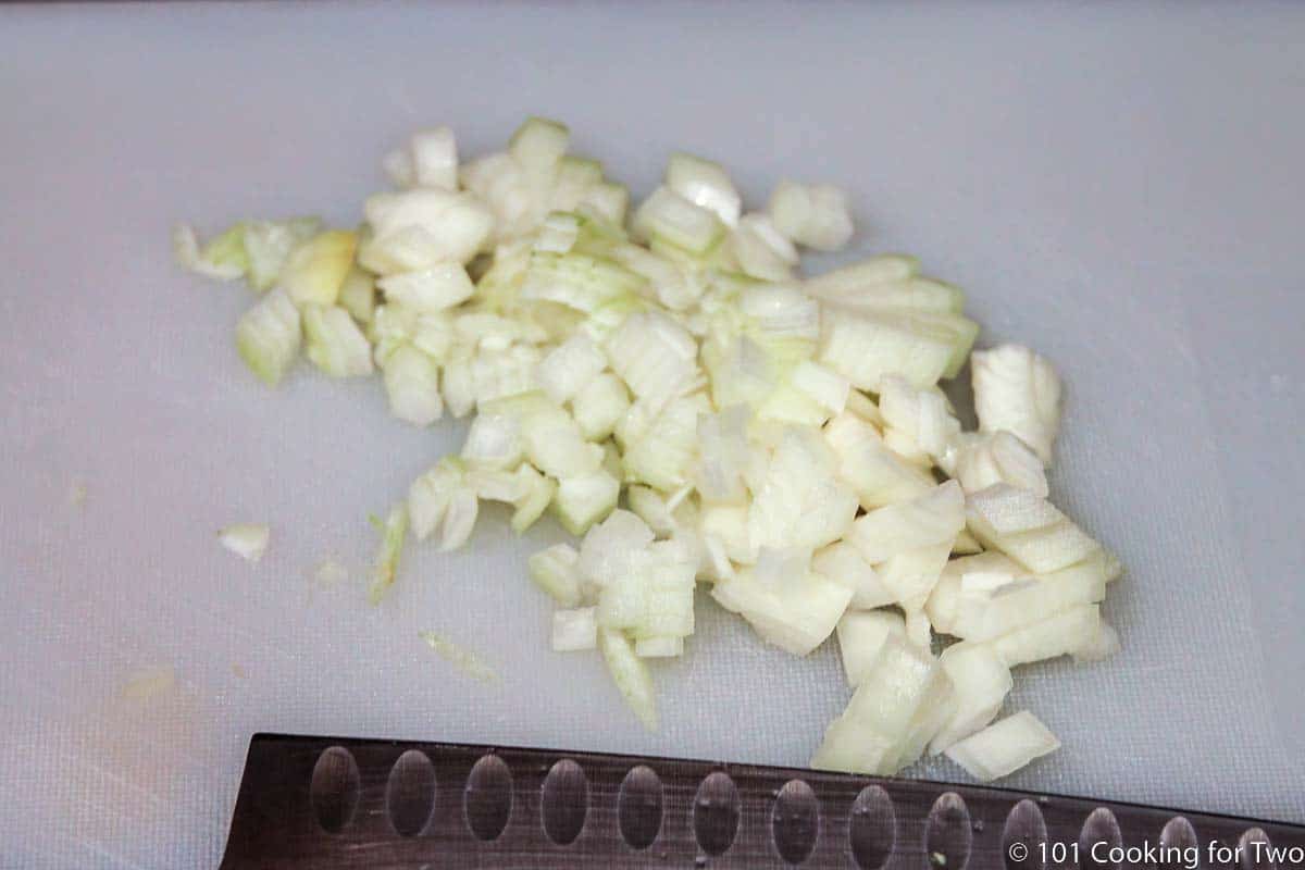 chopped onion on a white board.