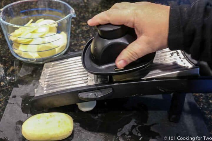 cutting potatoes with a mandolin