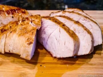 cutting turkey tenderloin on wooden board