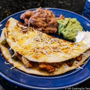 fajita quesadilla with trimmings on a blue plate