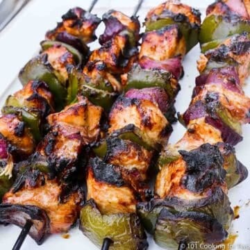 honey garlic chicken kabobs on a white board