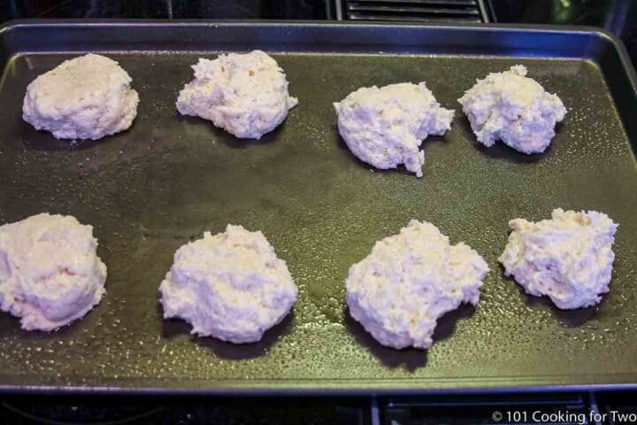 raw biscuits on baking sheet
