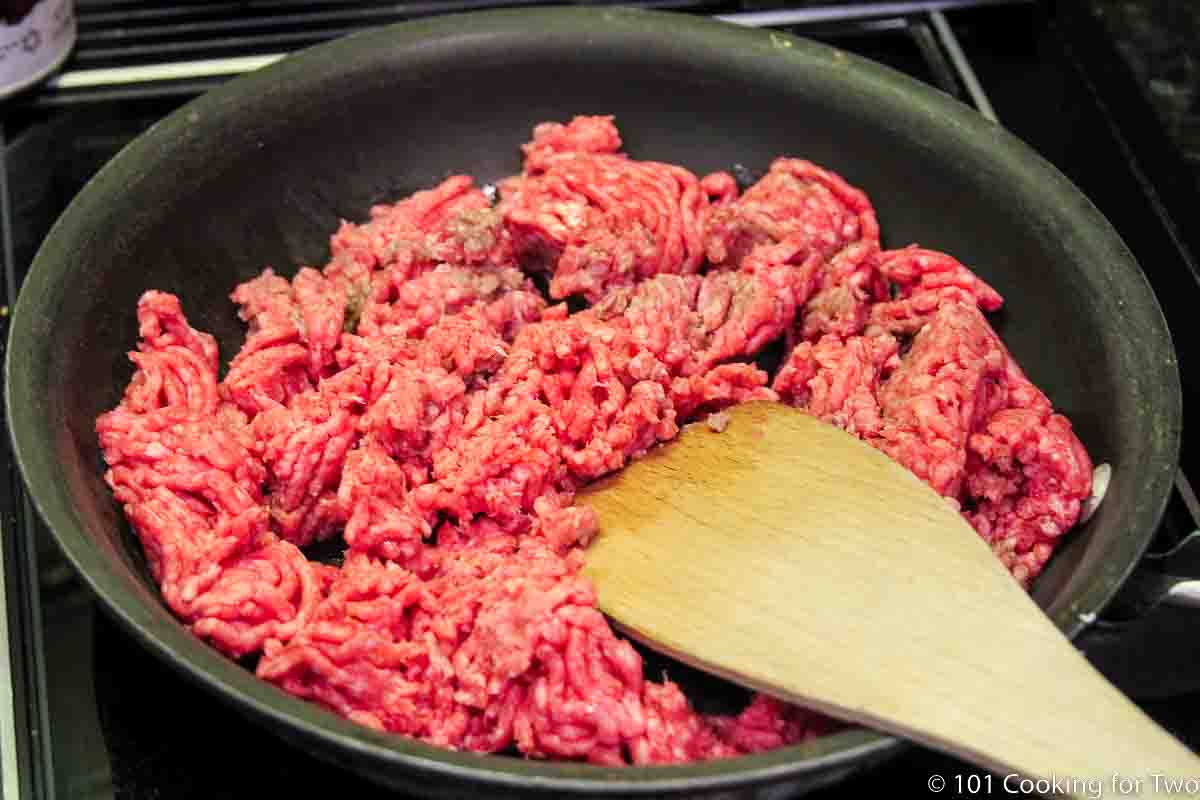 raw burger in large skillet.