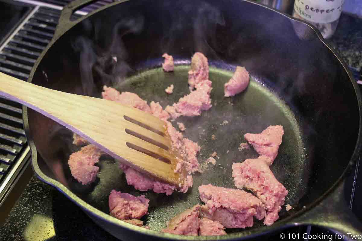 raw turkey sausage in black cast iron skillet.