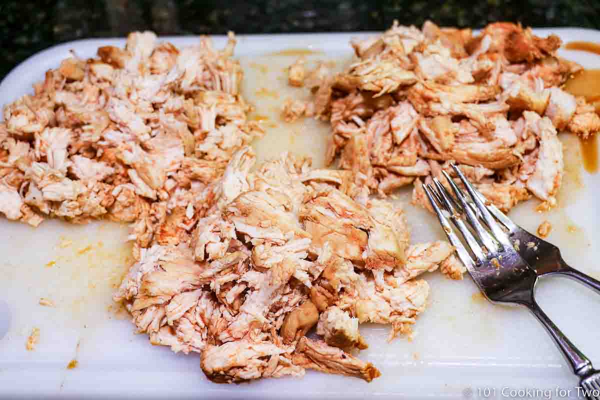 shredded chicken in three piles