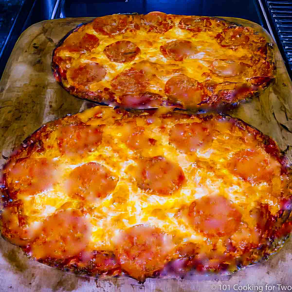 tortilla pizzas on a pizza stone.