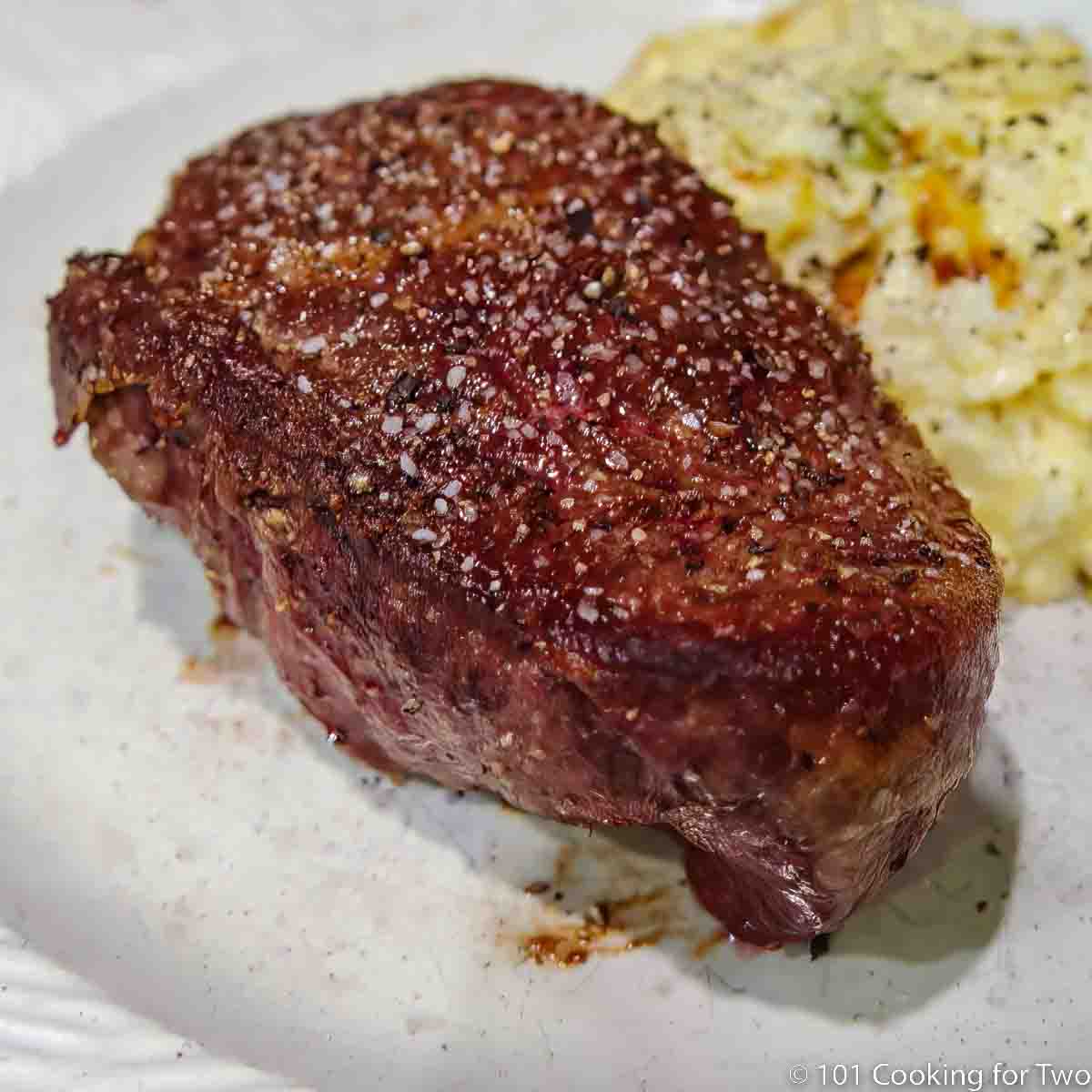 Baked filet mignon on white plate.