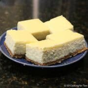 Cheesecake bars on a blue plate.