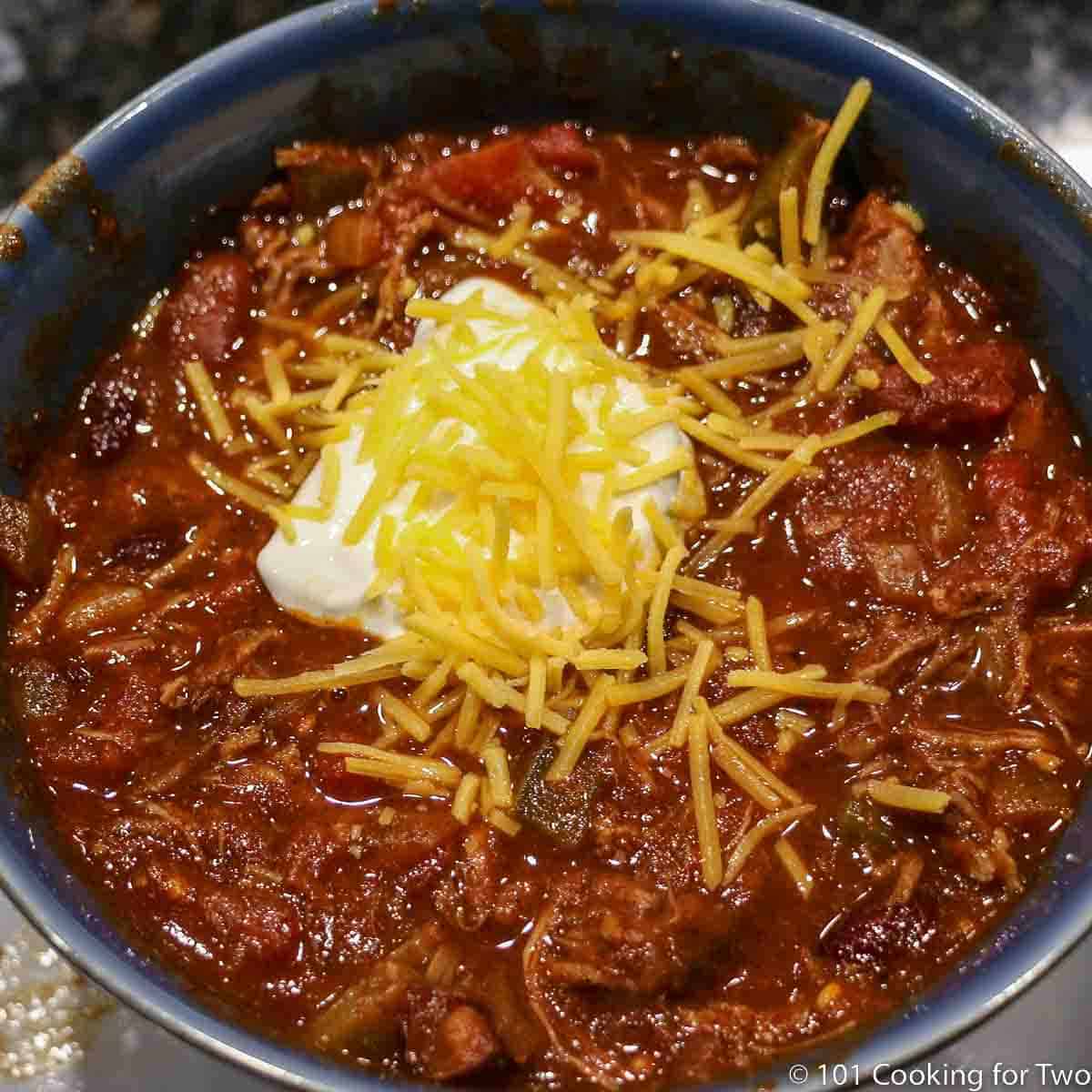 Chuck roast chili in a blue bowl