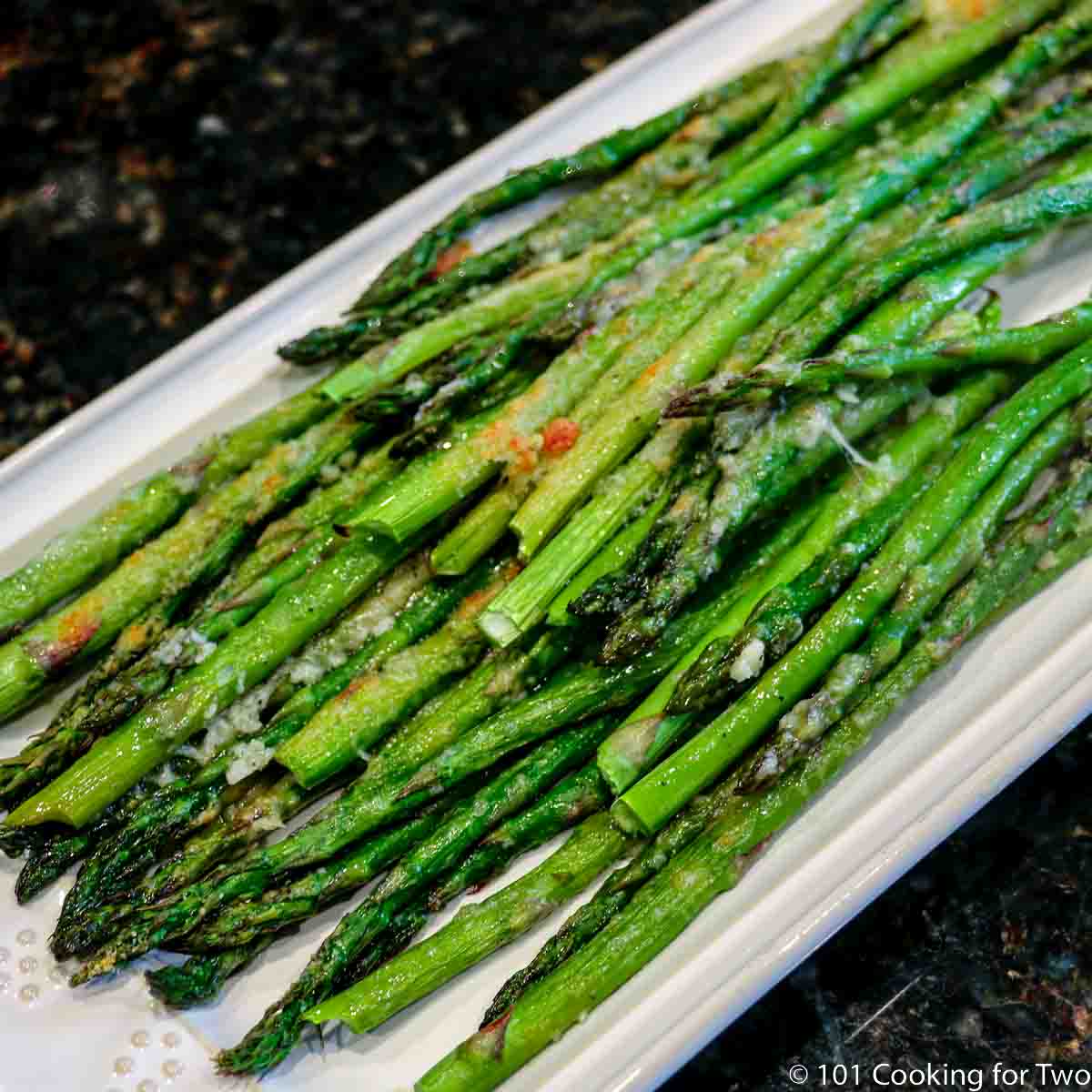 Parmesan baked asparagus on a white platter.