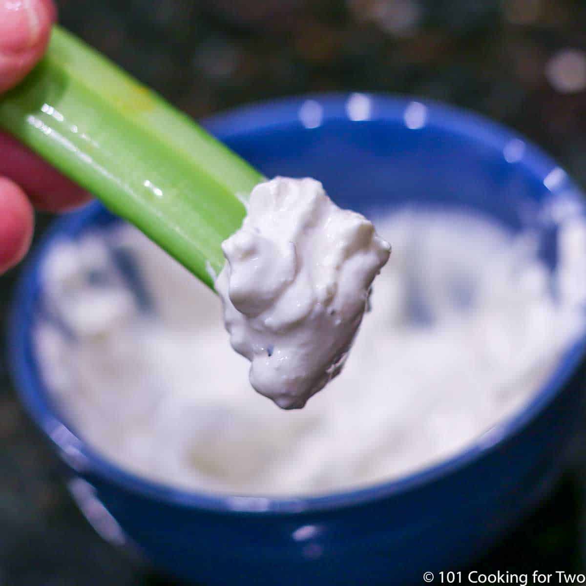 blue cheese dressing on a celery stick.