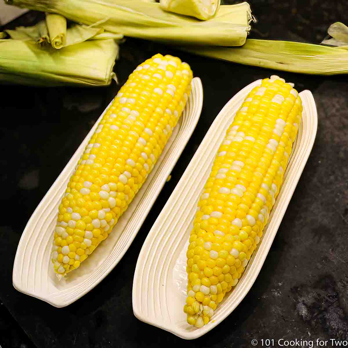 corn on the cob in serving trays.
