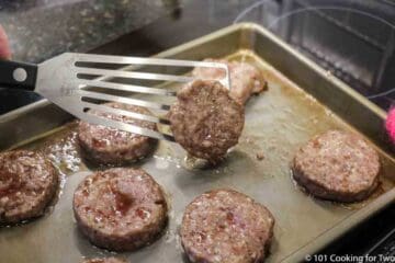 flipping sausage pattties during cooking