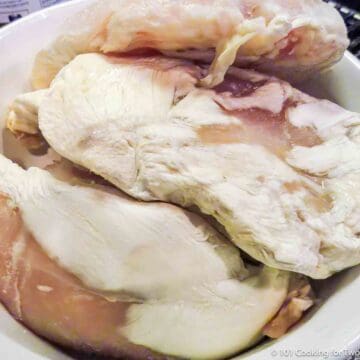 freezer burnt chicken on a white plate.