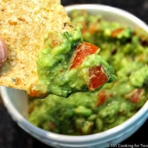 guacamole on a chip over a bowl