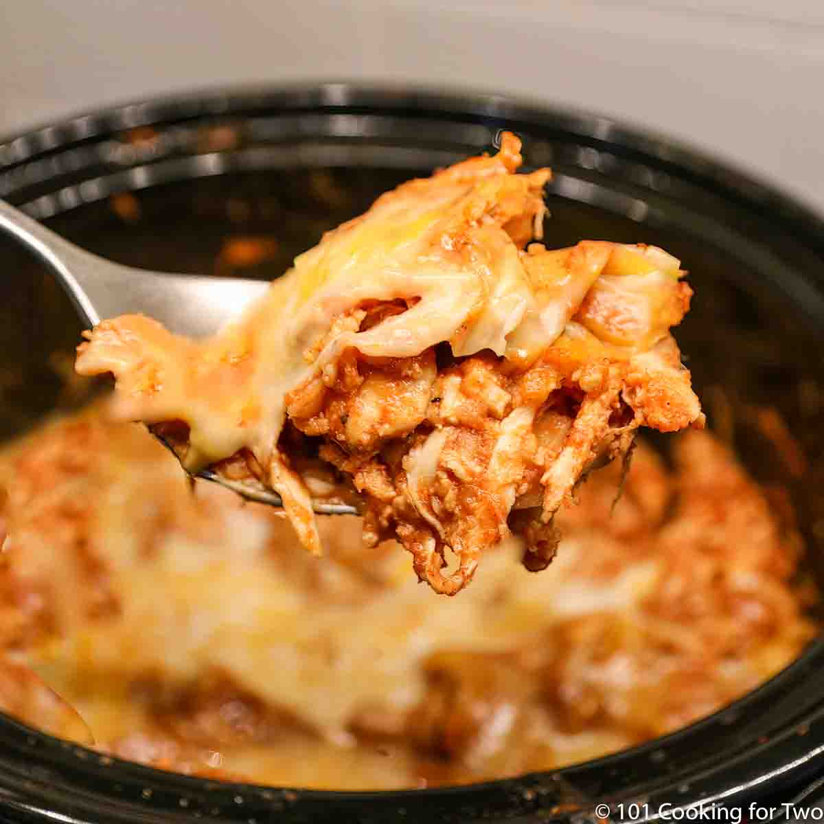 crock pot chicken enchiladas on spoon.