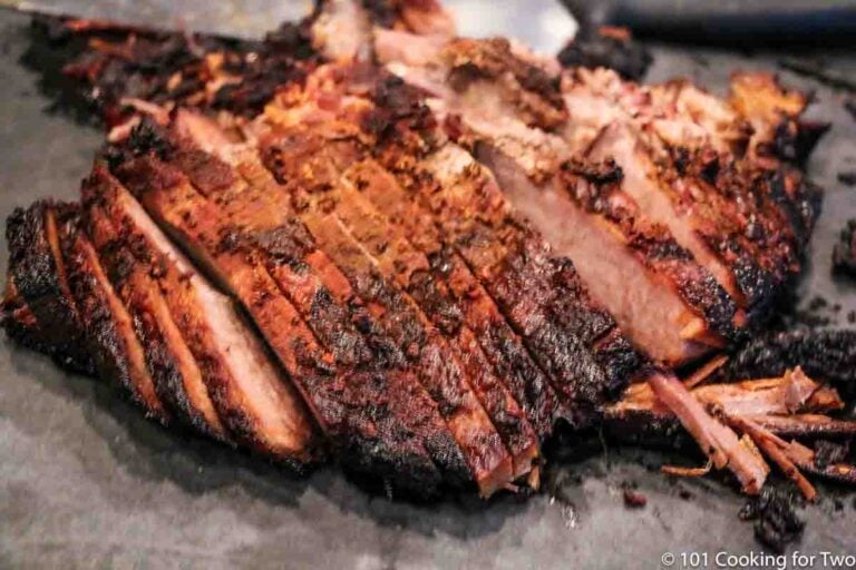 Cut brisket on a black board with knife