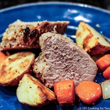 pork tenderloin slices on plate with vegetables