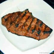 Grilled sirloin steak on a white plate.
