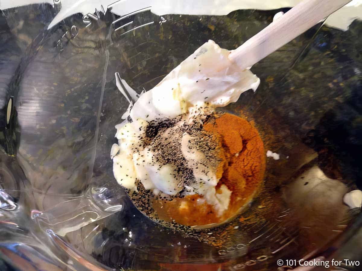 Mixing white BBQ sauce in a bowl.