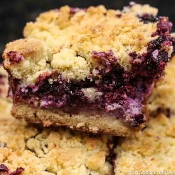 blueberry cream cheese bar on pile of bars