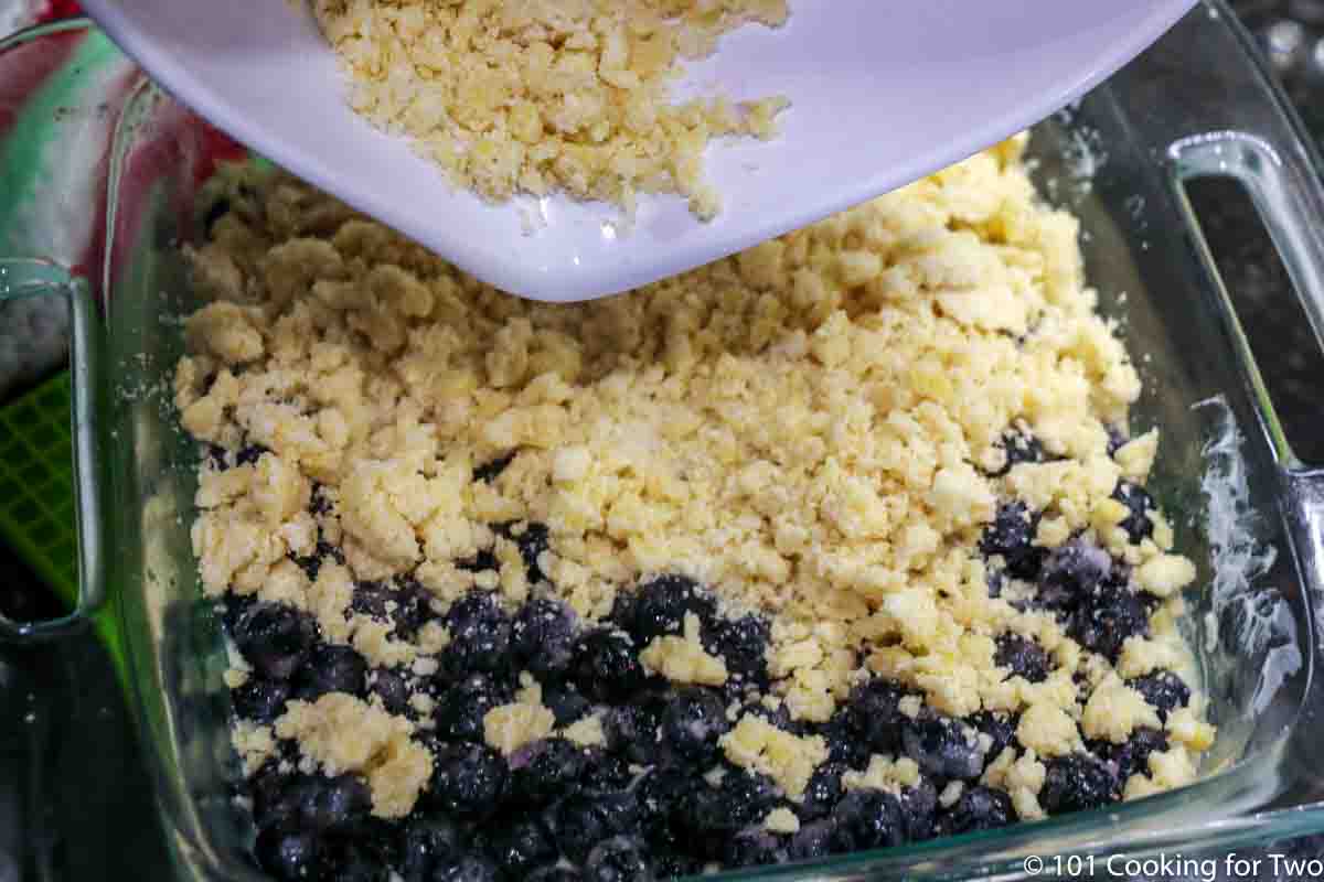 topping the dish with remaining crumb topping