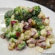 broccoli salad with bacon on white plate-2