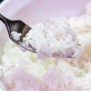 A fork full of cooked long grain rice