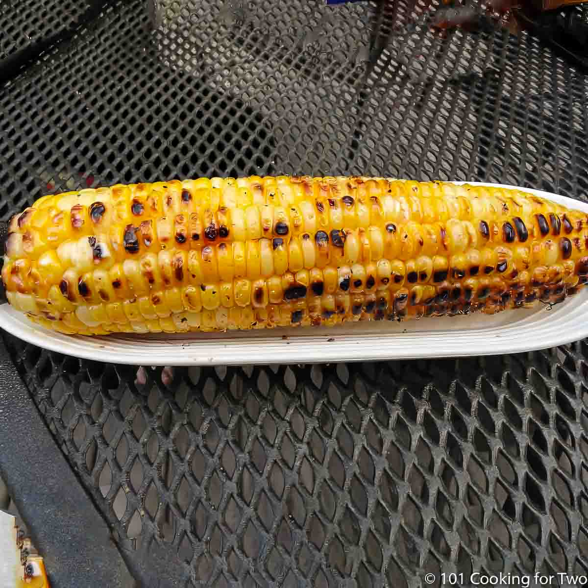 grilled corn on the cob in a holder.