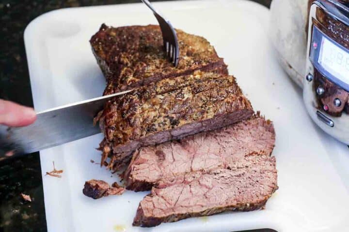 slicing beef roast on white board
