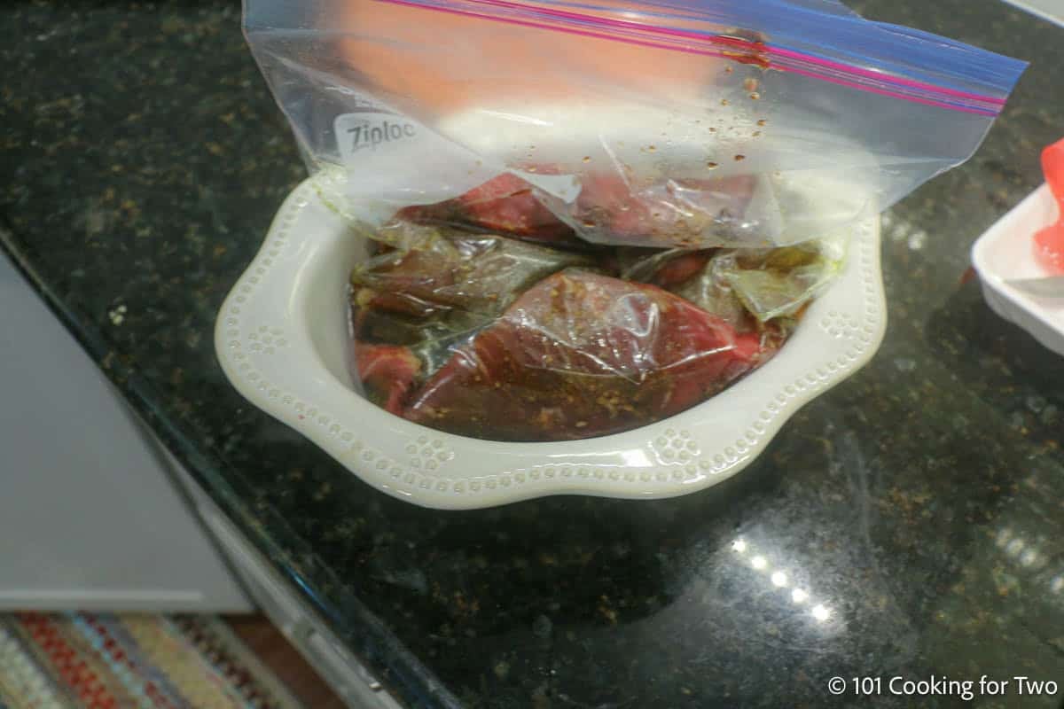 Flank steak marinated in a ziplock bag.