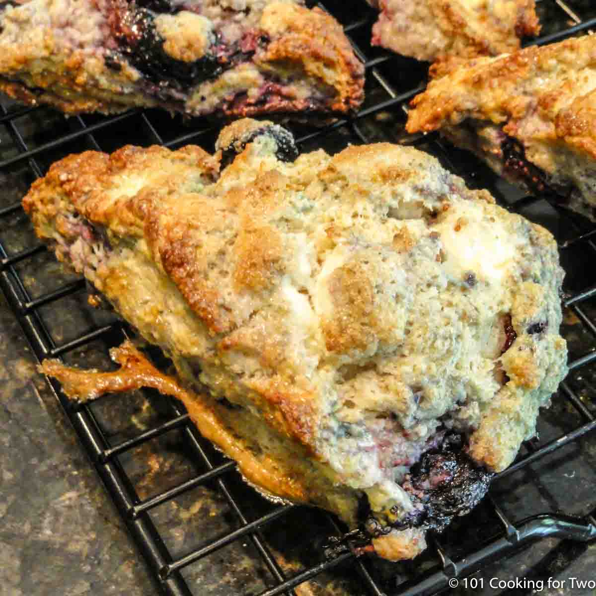 blueberry cream cheese scone on a rack.
