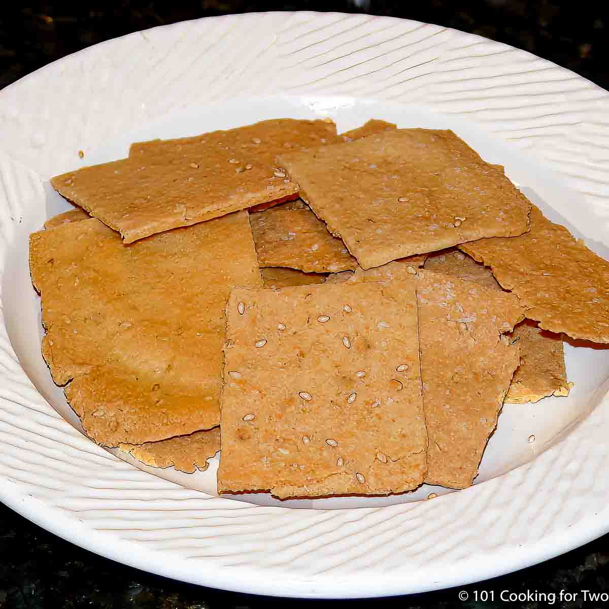 sesame crackers on a white plate.