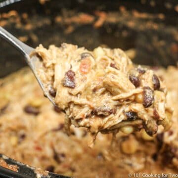 spoon full of fiesta chicken over the crock pot.