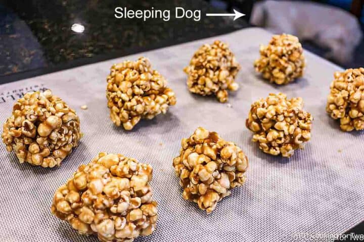 formed popcorn balls on a mat.
