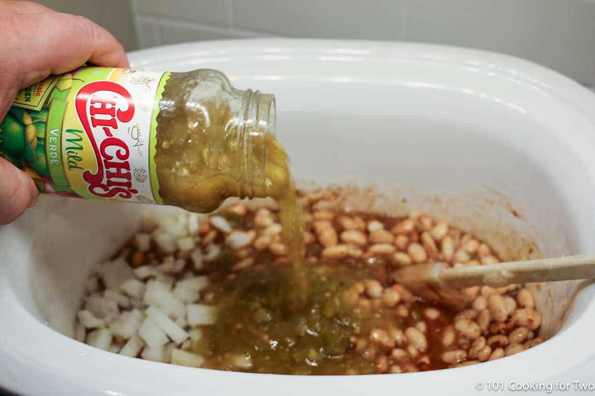 pouring salsa verde into crock pot.