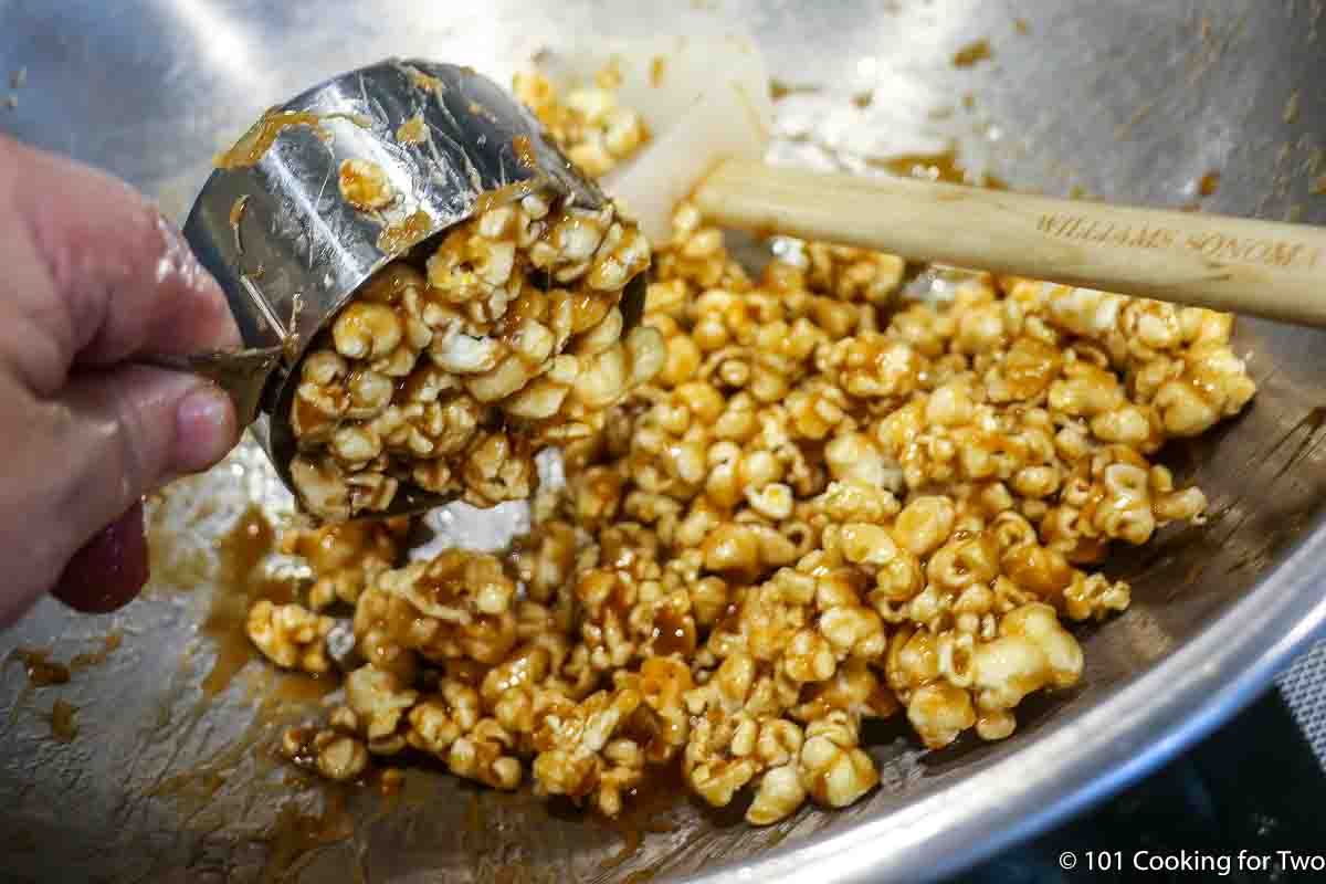 scooping caramel popcorn.