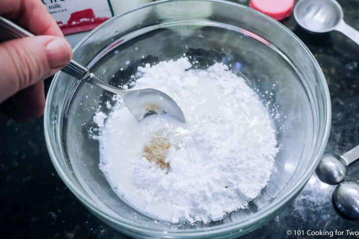 Mixing frosting in a bowl.