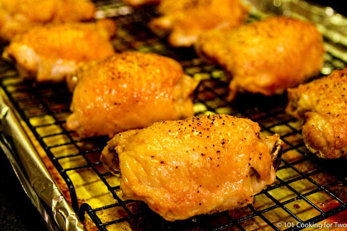 golden brown baked thighs on a rack,
