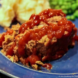 slice of meatloaf with ketchup.