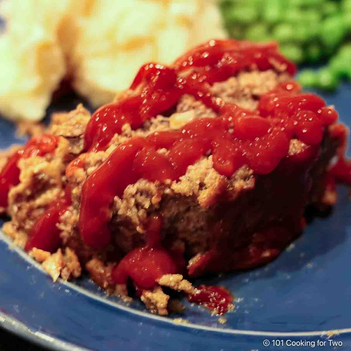 slice of meatloaf with ketchup.