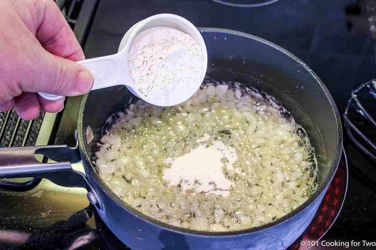 adding flour to butter and cooked onion.
