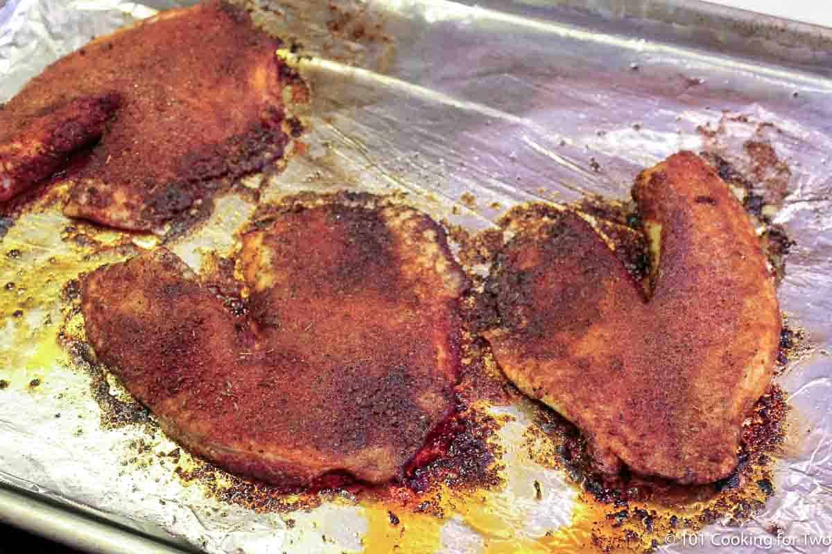 baked blackened tilapia on tray.