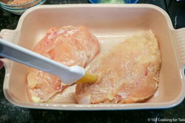 brushing raw breasts with butter.
